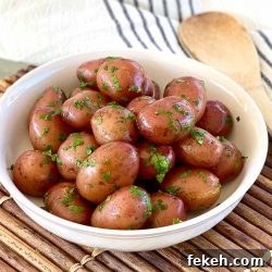 Garlic Butter Boiled Red Potatoes Recipe 3 Bowl of boiled red potatoes coated in butter and garnished with chopped parsley