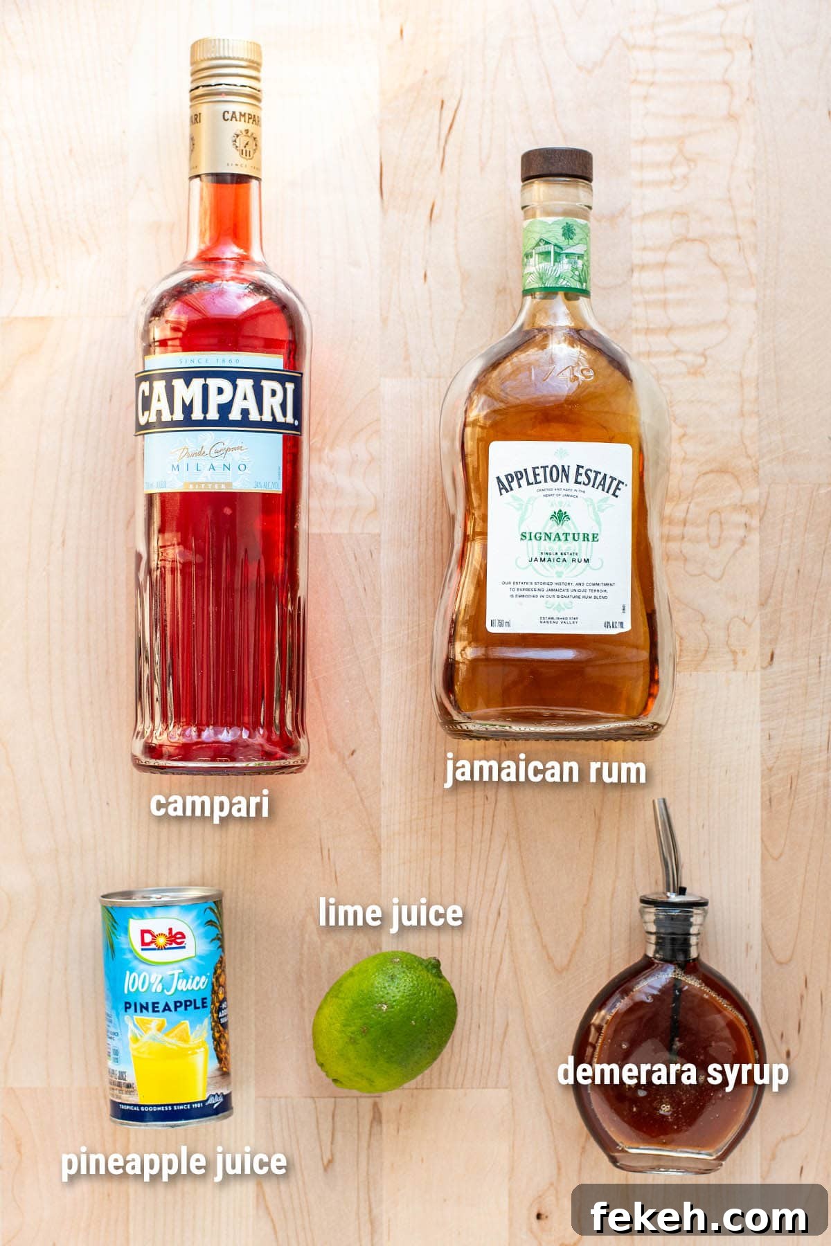 Jungle Bird cocktail ingredients laid out on a wooden cutting board.