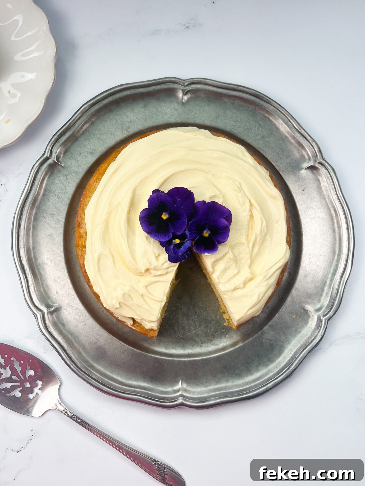 Mango Cake with Mascarpone Whipped Cream Frosting 3 Mango cake with mango mascarpone whipped cream frosting with a slice taken out
