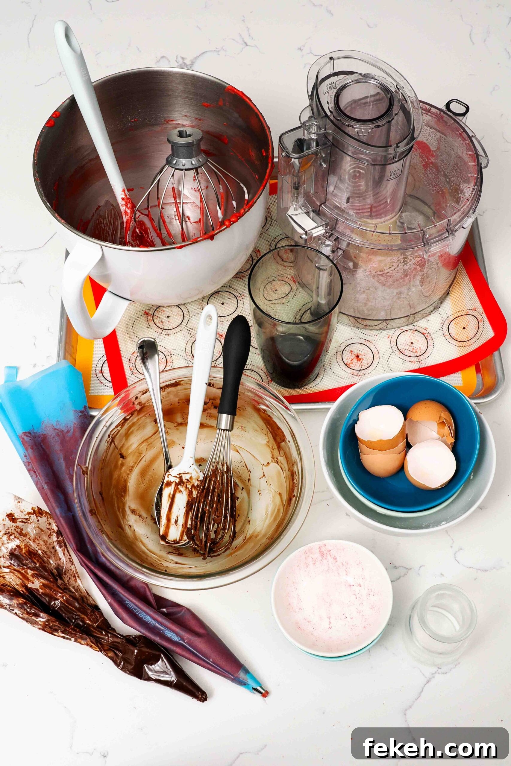 Dishes used to make chocolate raspberry macarons on a quartz countertop.