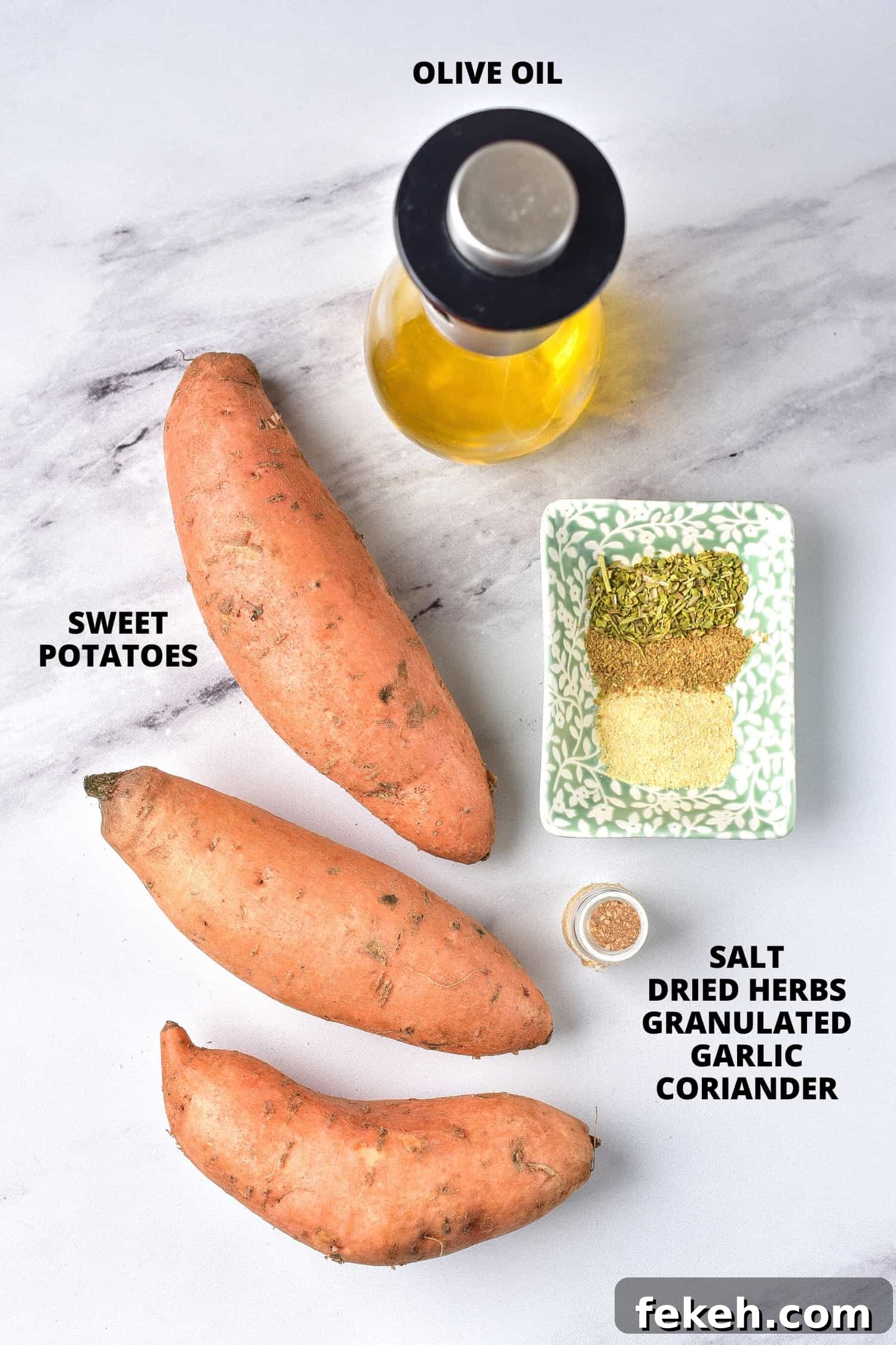 Ingredients required for air fried sweet potato wedges recipe laid out on marble board.