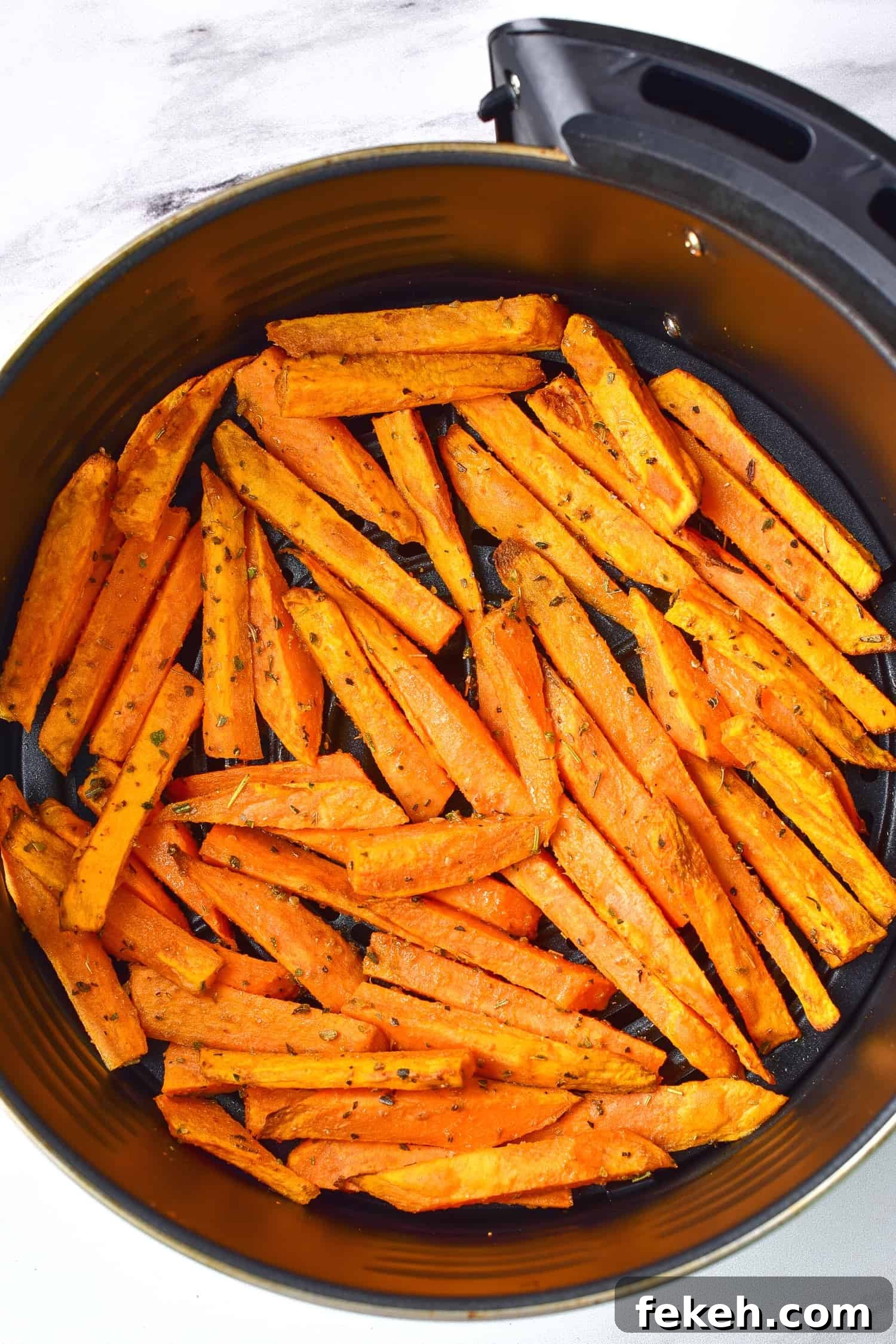 Air fried sweet potato wedges in air fryer.
