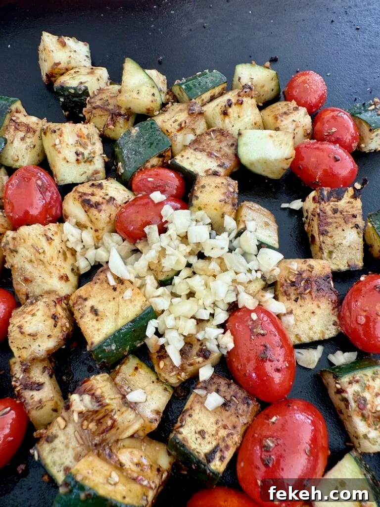 Blackstone Garlic Ranch Zucchini with Roasted Tomatoes 8 adding garlic to zucchini