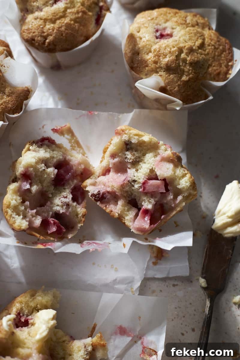 Strawberry Almond Muffins Recipe with Crispy Streusel Topping 12 A halved muffin showing the strawberry chunks inside.