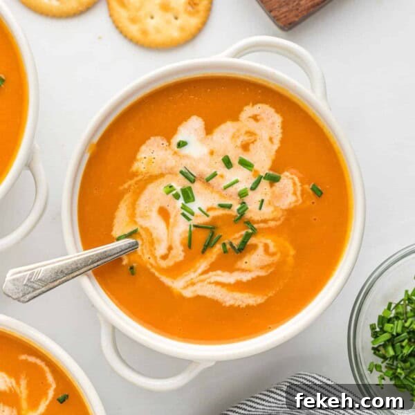 Instant Pot Black Bean Soup with Soaked or Dry Beans 12 Carrot soup in a white bowl topped with chives and a swirl of cream.
