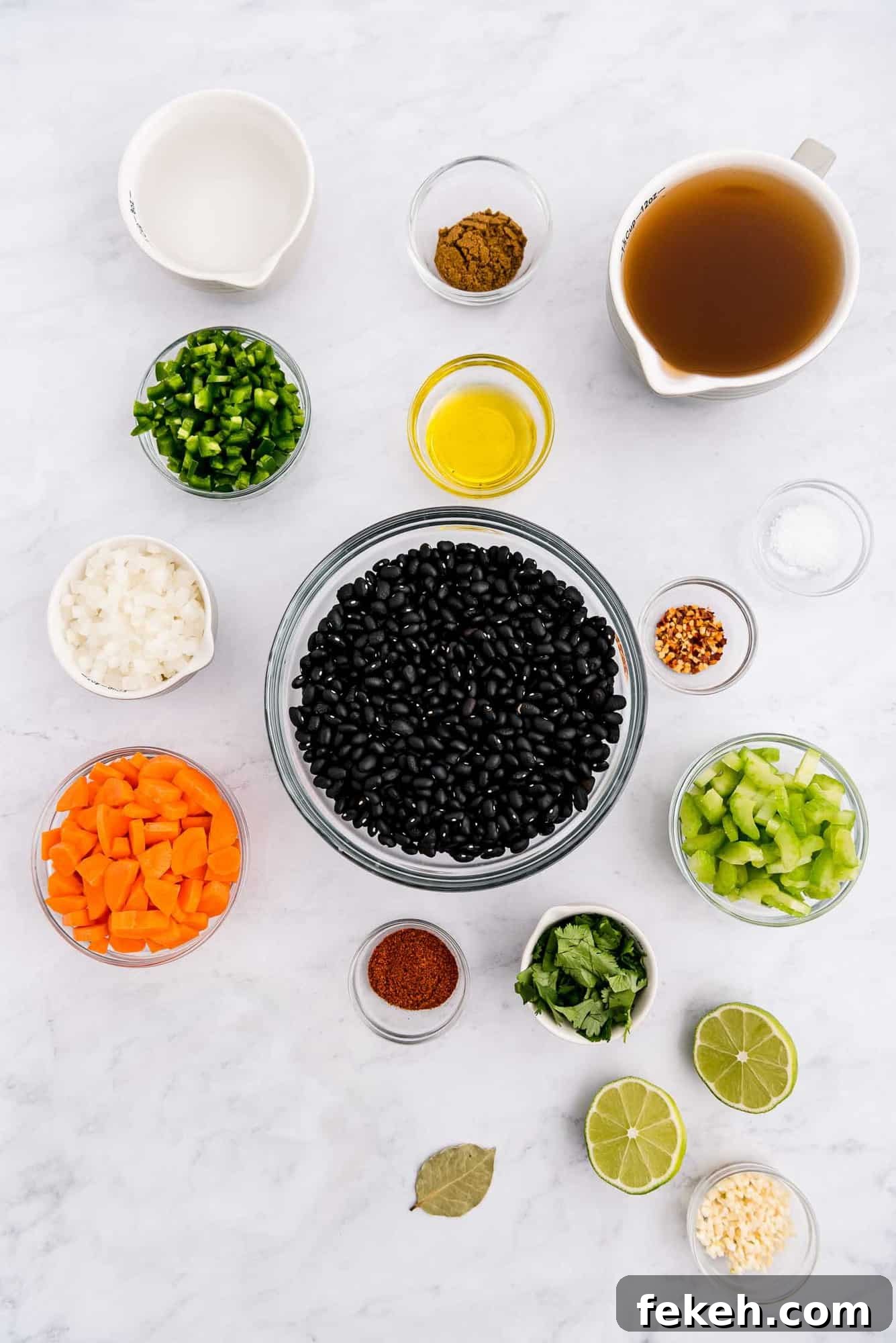 Instant Pot Black Bean Soup with Soaked or Dry Beans 4 Overhead view of colorful ingredients in glass bowls, including black beans, carrots, jalapeno, and more.