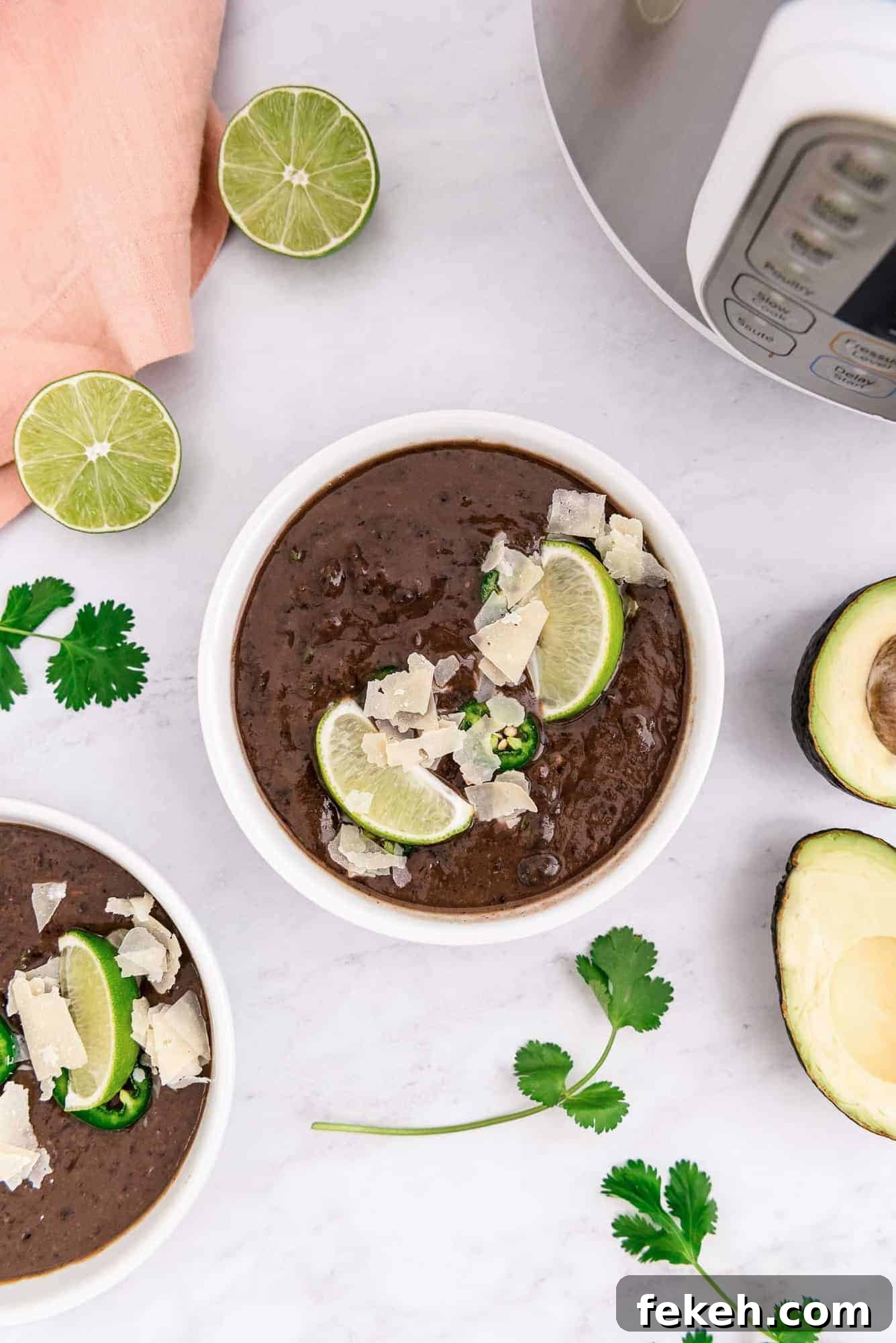 Instant Pot Black Bean Soup with Soaked or Dry Beans 10 Dark brown soup in a bowl, garnishes all around.