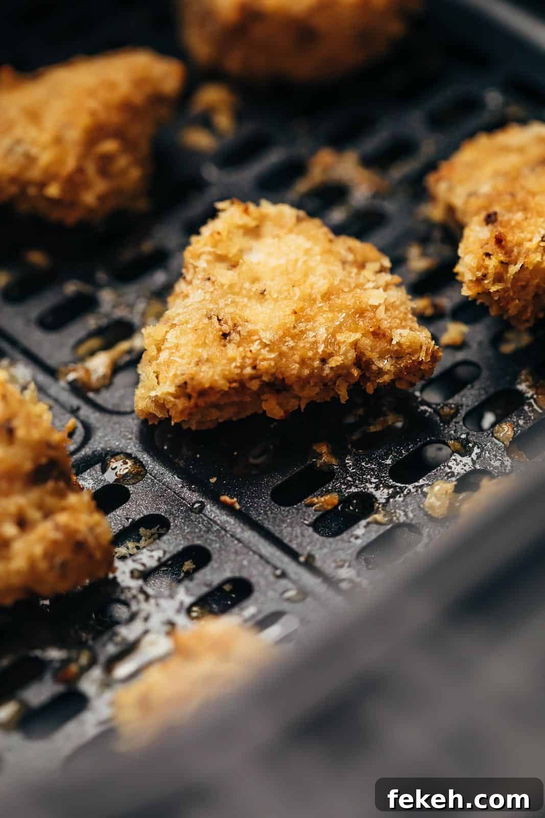 Air Fryer Guide: What It Is, How It Works & Top Recipes 5 Closeup of Chicken Nugget in the Air Fryer basket