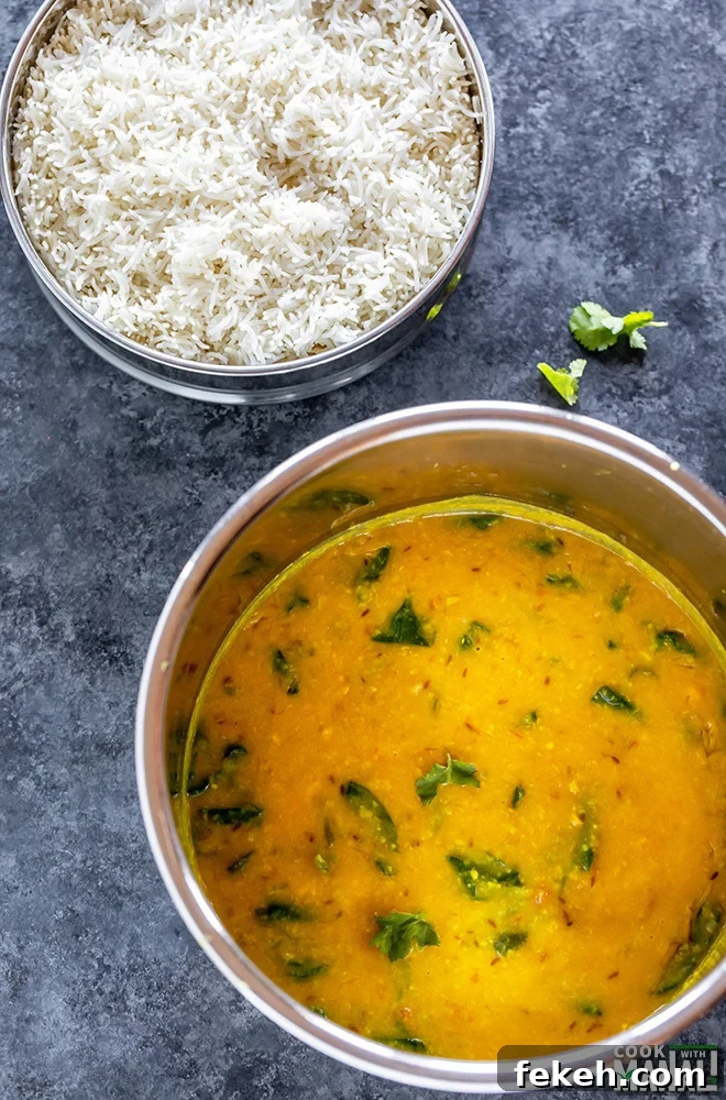 instant pot with cooked dal and a bowl of rice in the back