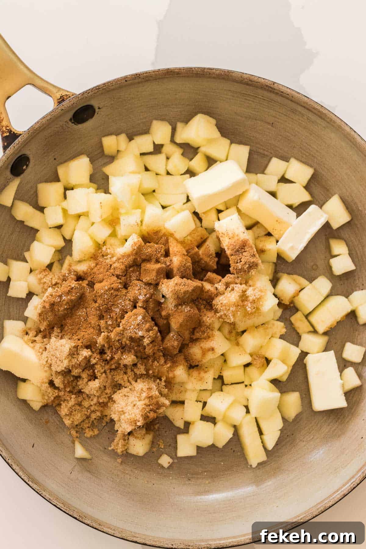 diced apples with butter, brown sugar and cinnamon in a saute pan