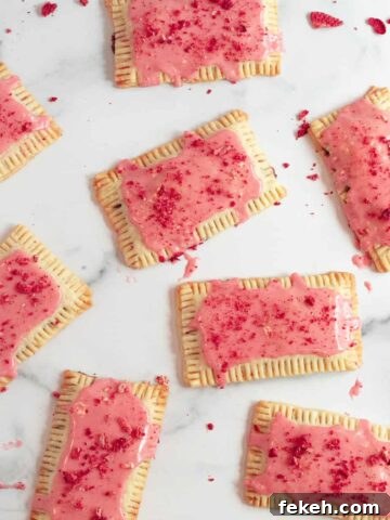 chocolate pop tarts with strawberry glaze on a white marble counter