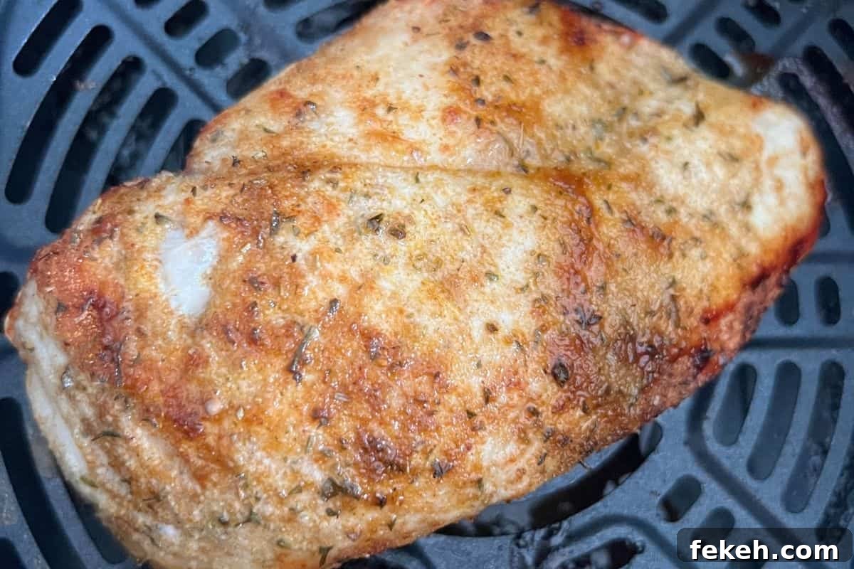 Applebee's Chicken Fajita Roll-Up Copycat Recipe 3 Chicken breast cooking in air fryer.