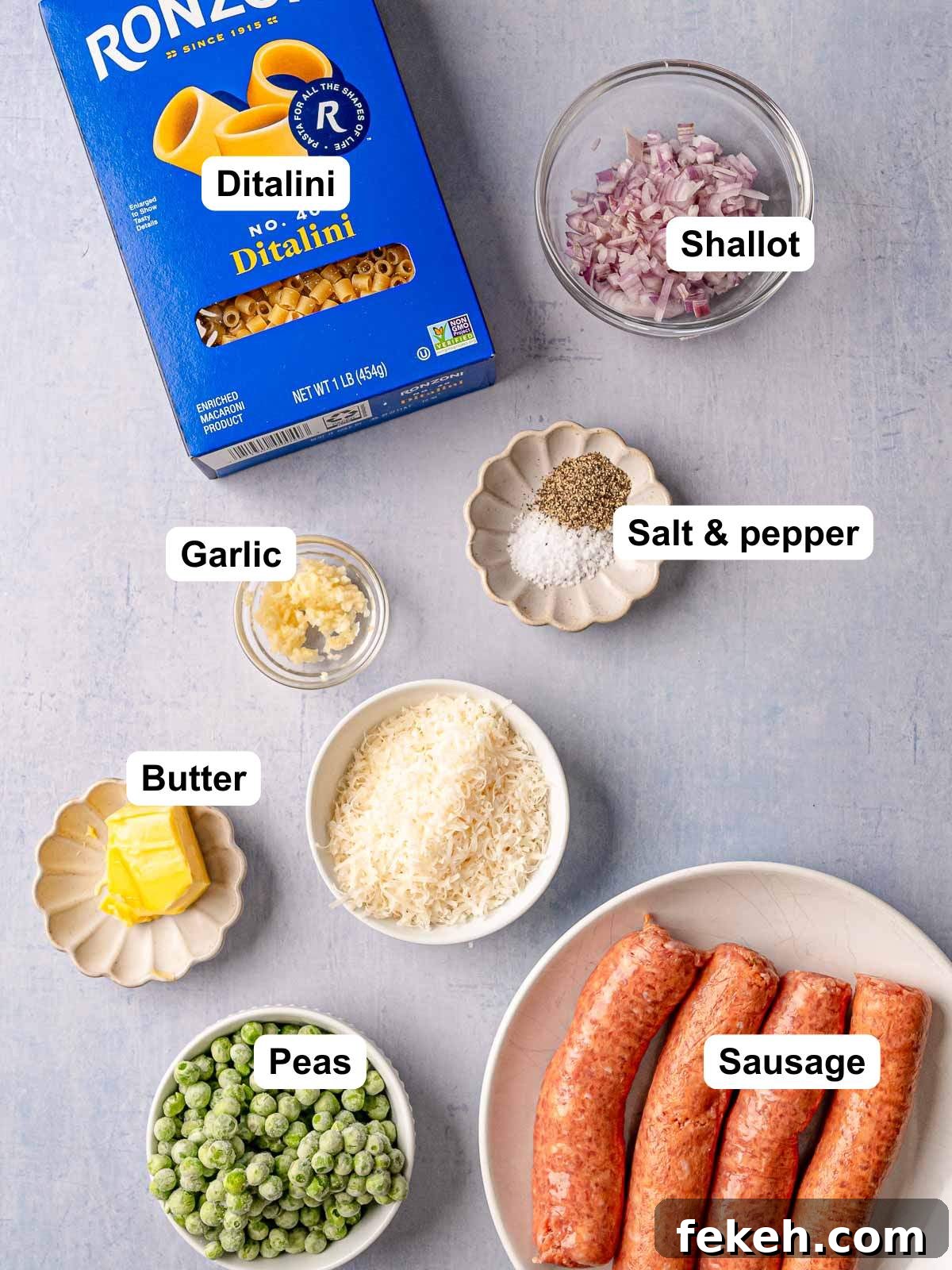Ditalini Pasta with Italian Sausage and Peas 3 Labeled ingredient layout showing a box of Ronzoni ditalini pasta, diced shallot, minced garlic, salt and pepper, butter, grated Parmesan, frozen peas, and Italian sausage links.