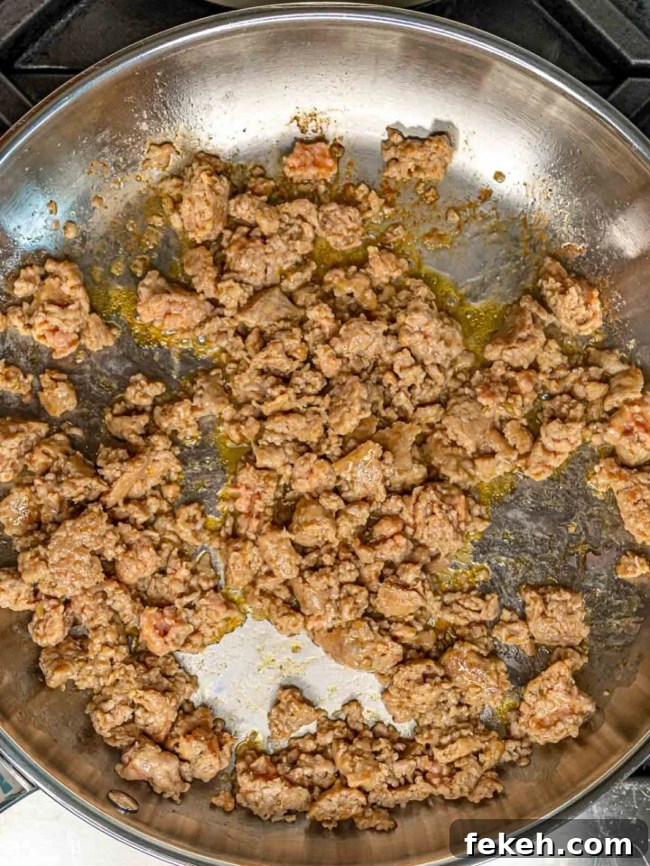 Ditalini Pasta with Italian Sausage and Peas 4 Crumbled Italian sausage browning in a stainless steel skillet with rendered fat.