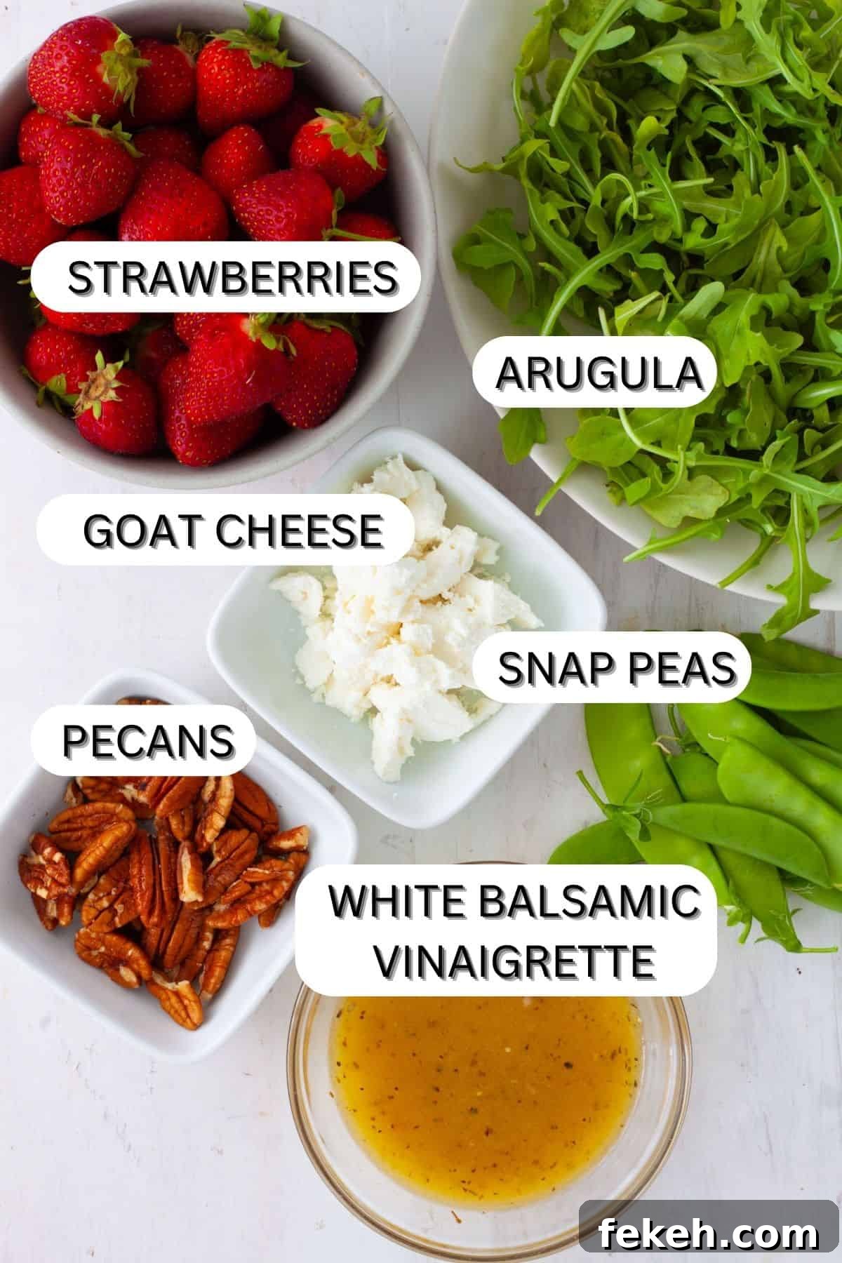 Strawberry Goat Cheese Salad with Balsamic Glaze 3 Ingredients for strawberry and goat cheese salad on a white table.