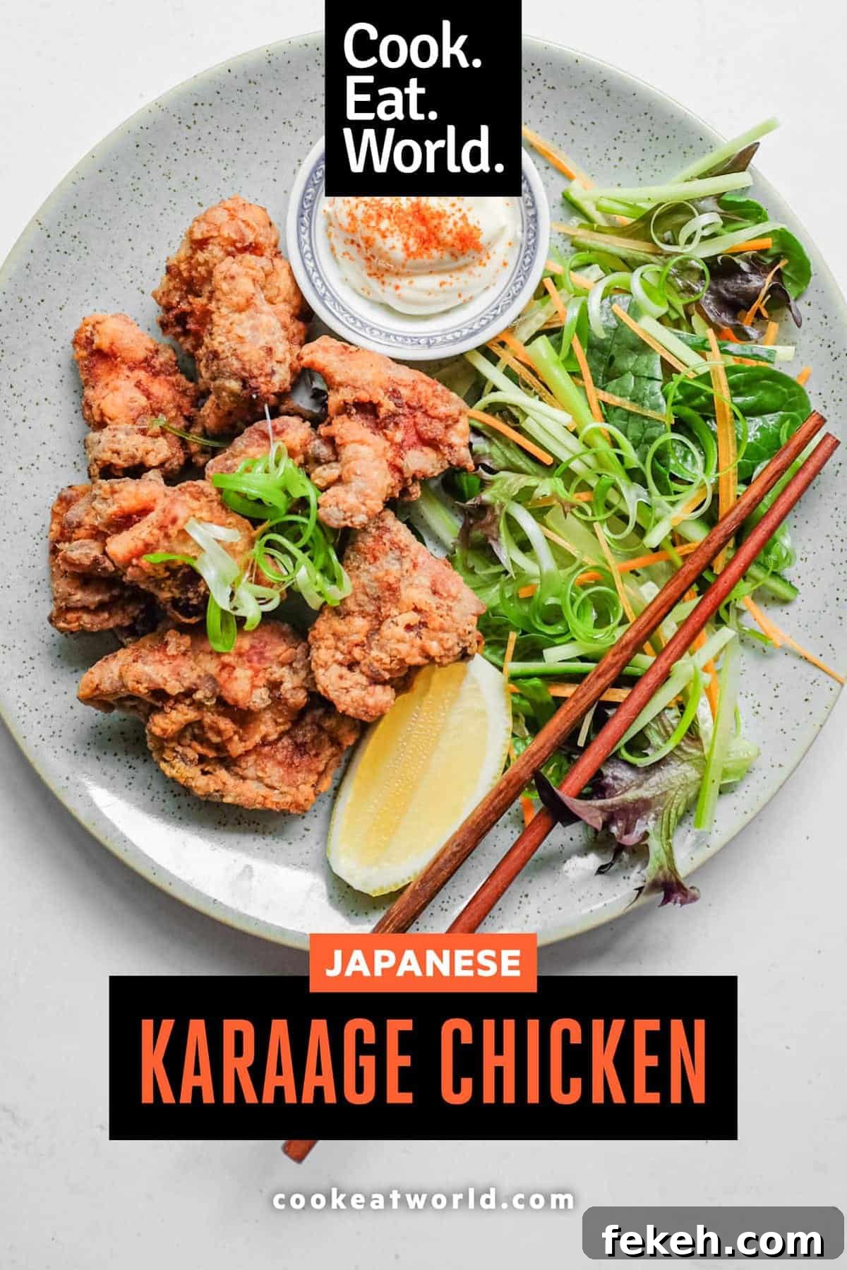 A plate of Japennese karaage chicken with a side salad, lemon wedge, and mayonnaise