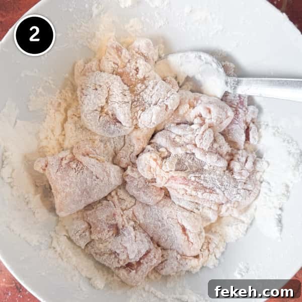 coating karaage chicken pieces in potato starch