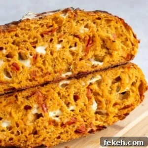 Sourdough Pizza Bread Recipe for Crispy, Flavorful Crust 18 A loaf of sourdough pizza bread, cut open and sitting on a cutting board.