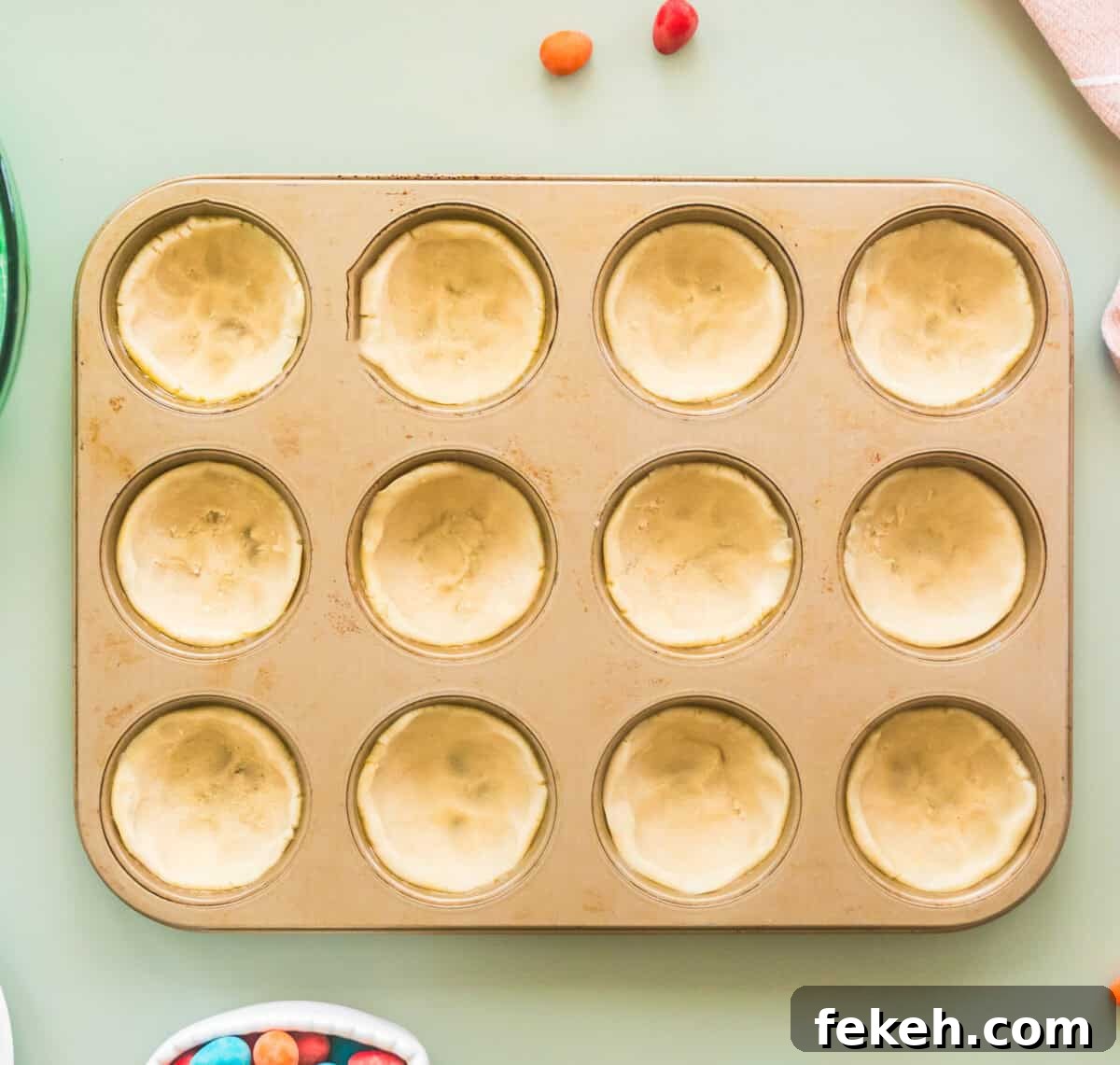 Easter Cookie Recipes for Spring Baking and Festive Treats 5 pressing cookie dough into muffin tin