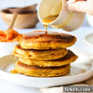 Gluten-Free Pumpkin Pancakes Recipe for Fluffy Fall Mornings 12 pouring maple syrup onto a stack of pancakes.