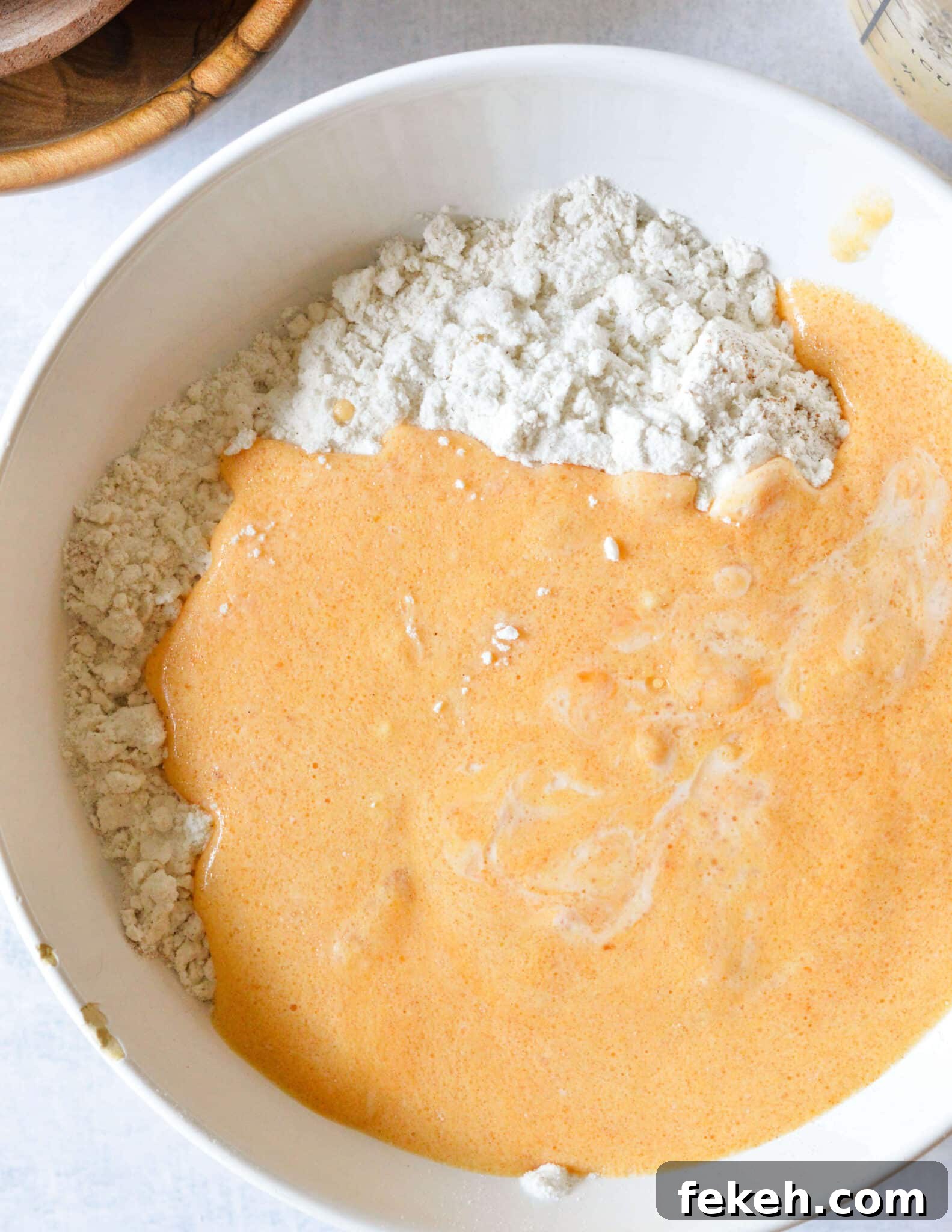 Gluten-Free Pumpkin Pancakes Recipe for Fluffy Fall Mornings 6 a bowl of gluten free flour with pumpkin and buttermilk mixed together.