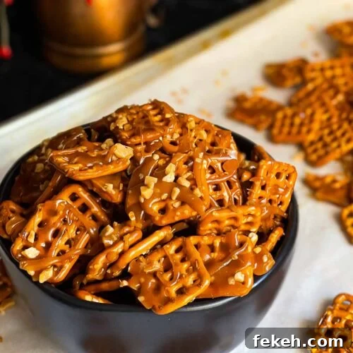 Crunchy Butter Toffee Pretzel Recipe — Sweet & Salty Treat 11 Butter toffee pretzels in a dark bowl on the baking sheet.