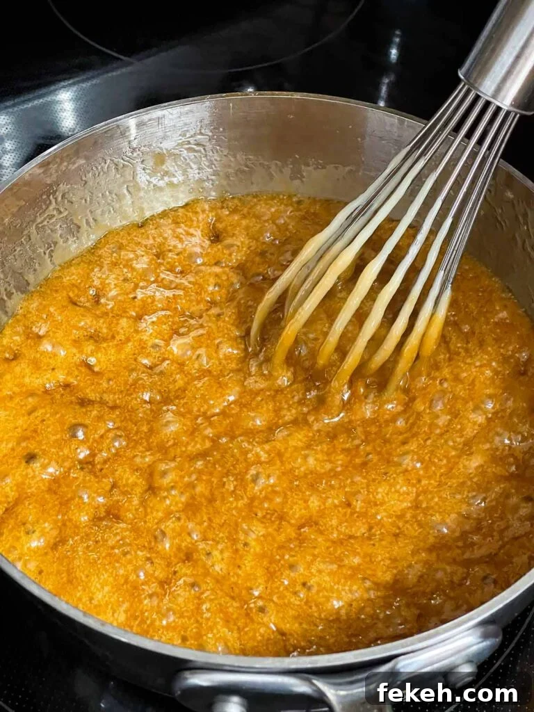 Crunchy Butter Toffee Pretzel Recipe — Sweet & Salty Treat 5 Toffee mixture boiling in a metal saucepan.