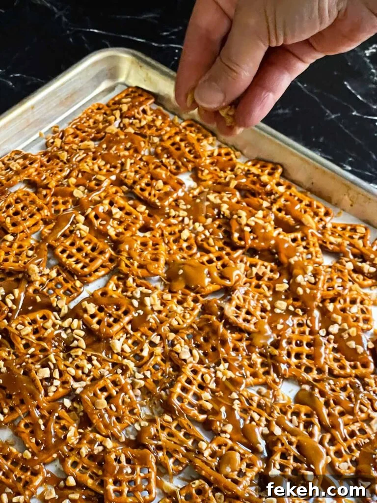 Crunchy Butter Toffee Pretzel Recipe — Sweet & Salty Treat 7 Sprinkling toffee bits over the warm drizzled toffee on the pretzels.