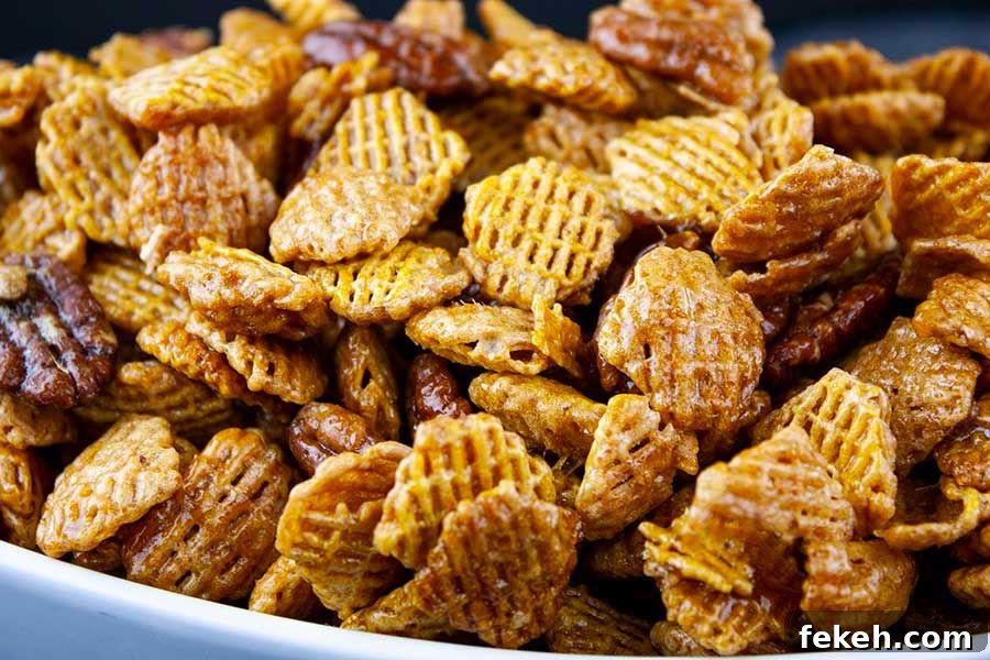 Crunchy Butter Toffee Pretzel Recipe — Sweet & Salty Treat 10 Praline Crunch Snack Mix in a white bowl.