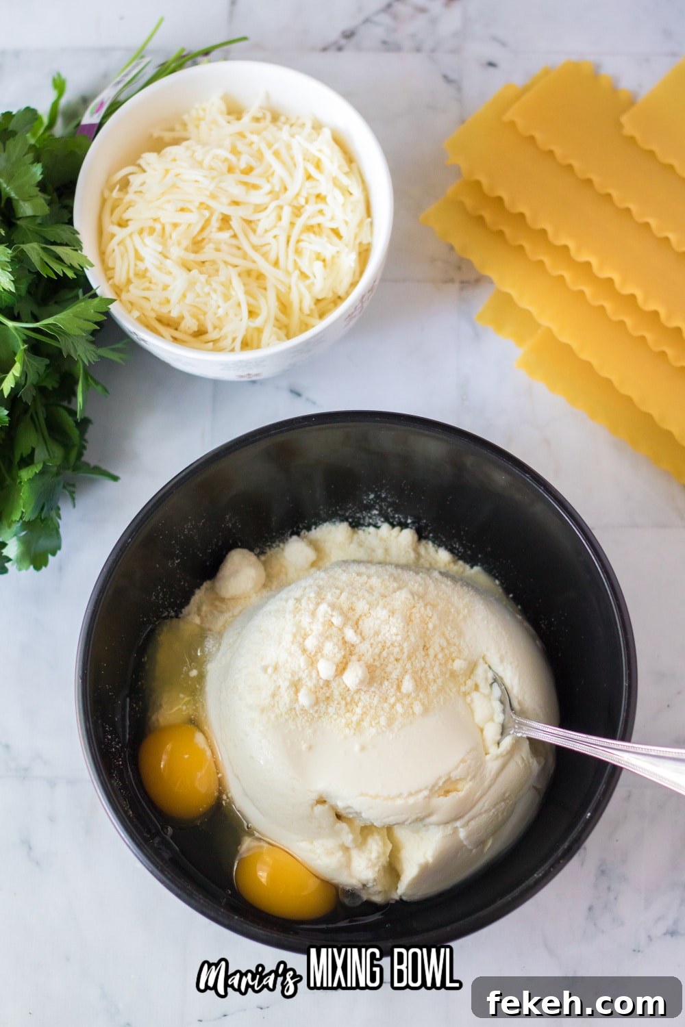 ricotta cheese, eggs, and parmesan chese in a black bowl with a metal spoon