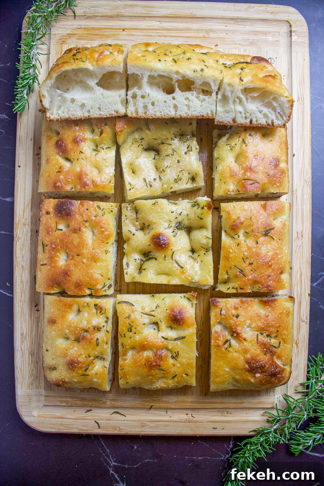 Crispy Sourdough Focaccia Recipe for Flavorful Homemade Bread 7 rosemary sourdough focaccia on cutting board with rosemary sprigs