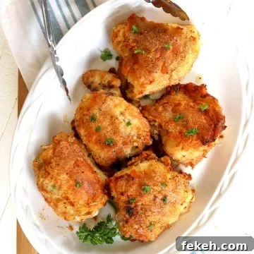 Southern-Style Oven-Baked Chicken Thighs Recipe 4 A white oval platter served with southern baked chicken thighs