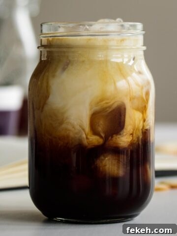 Iced Brown Sugar Oatmilk Shaken Espresso served in a mason jar.