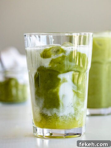 Two glasses of iced pineapple matcha drink.