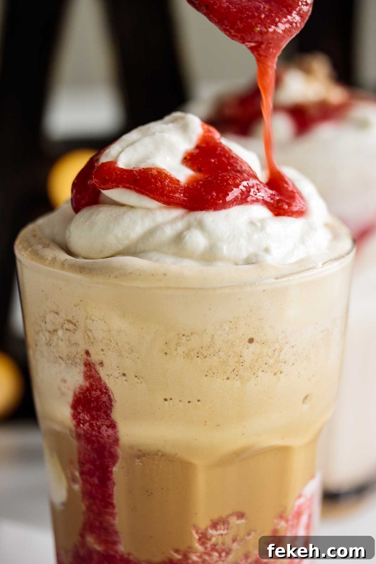Starbucks Strawberry Funnel Cake Frappuccino Review & Order Guide 5 Strawberry puree pouring over whipped cream.