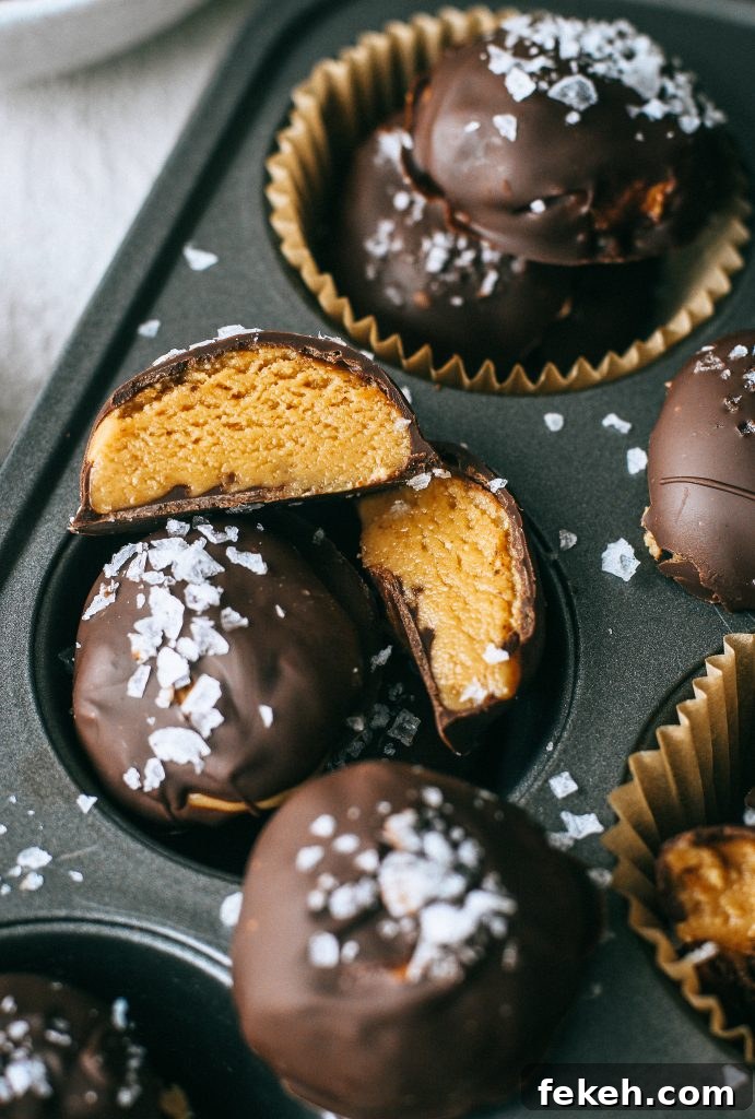 Peanut Butter Truffles with Lighter Ingredients and Less Sugar 3 peanut butter chocolate truffles with flaky sea salt in a cupcake tin