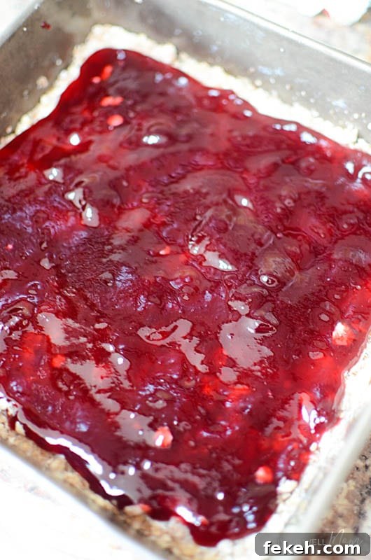 Raspberry jam over an oatmeal bar base