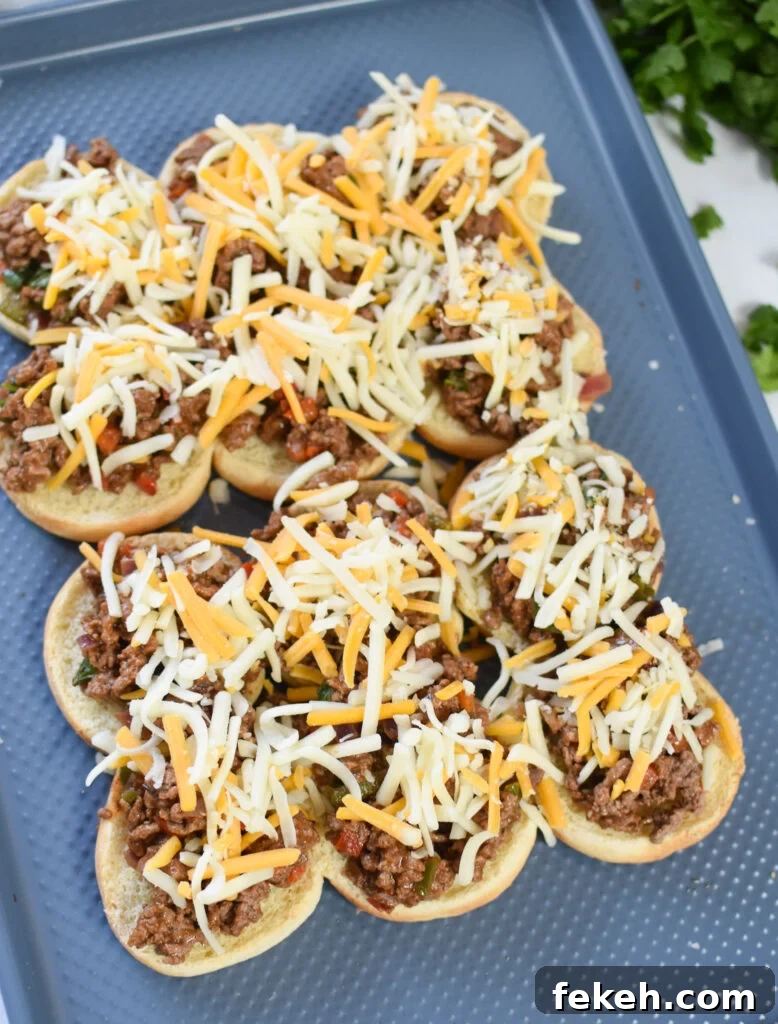 Taco Beef Sliders: Quick Party Sliders with Spicy Beef & Cheese 11 Taco Beef Sliders cheese on the beef on the buns.