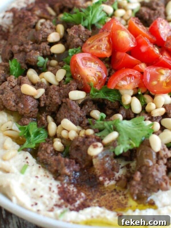 Taco Beef Sliders: Quick Party Sliders with Spicy Beef & Cheese 13 Hummus with Spiced Beef and Toasted Pine Nuts on white plate