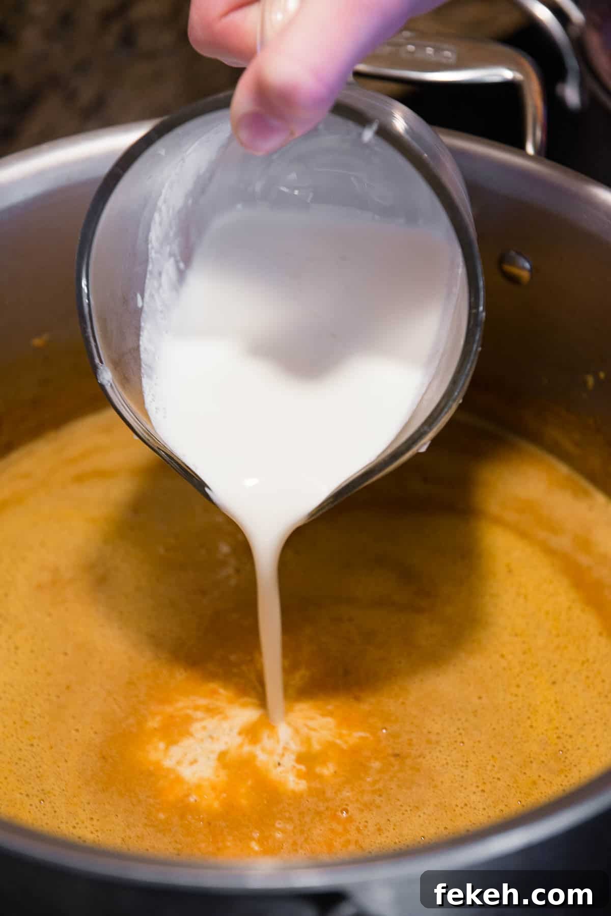 adding heavy cream to soup