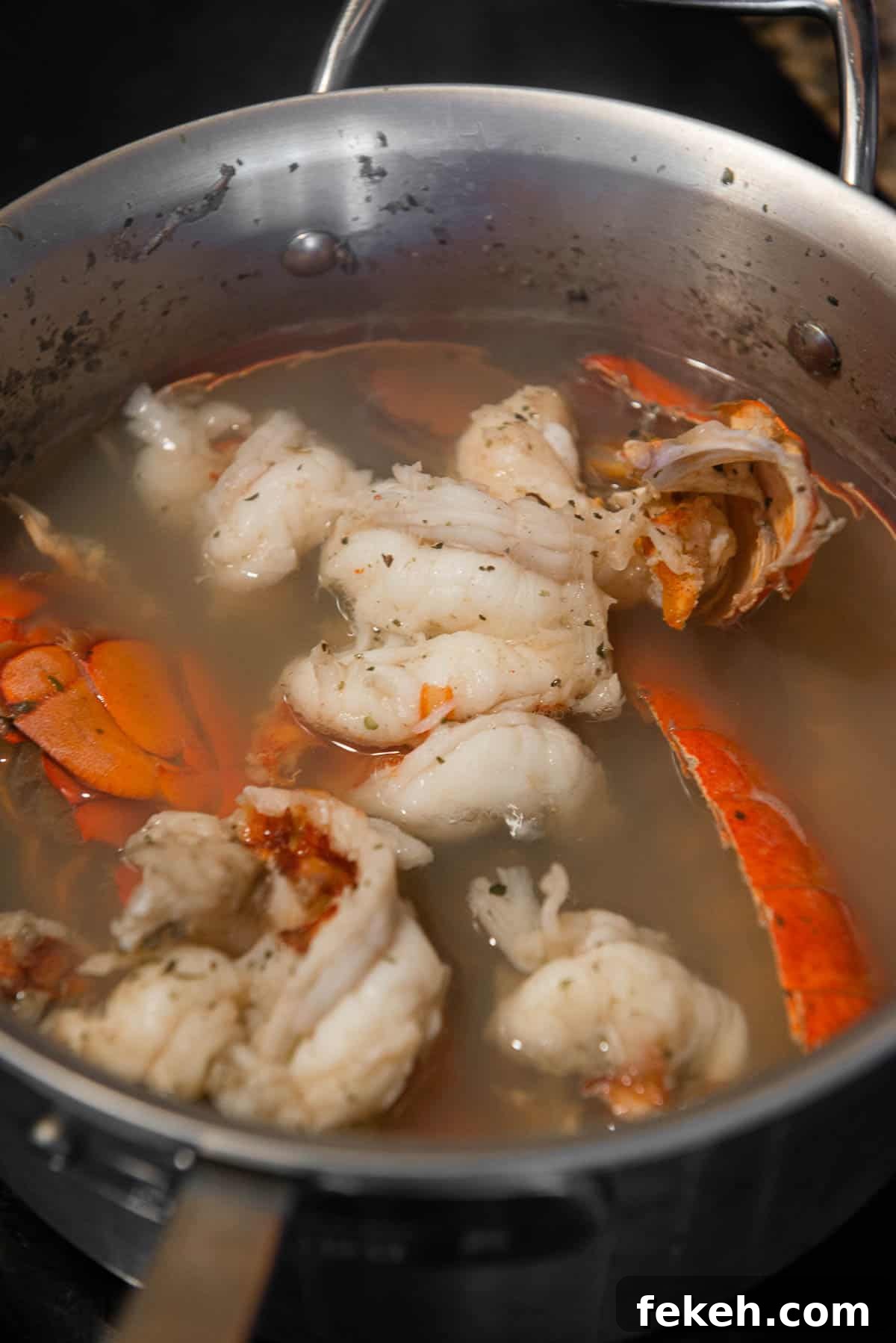 lobster meat and shells cooking in stock