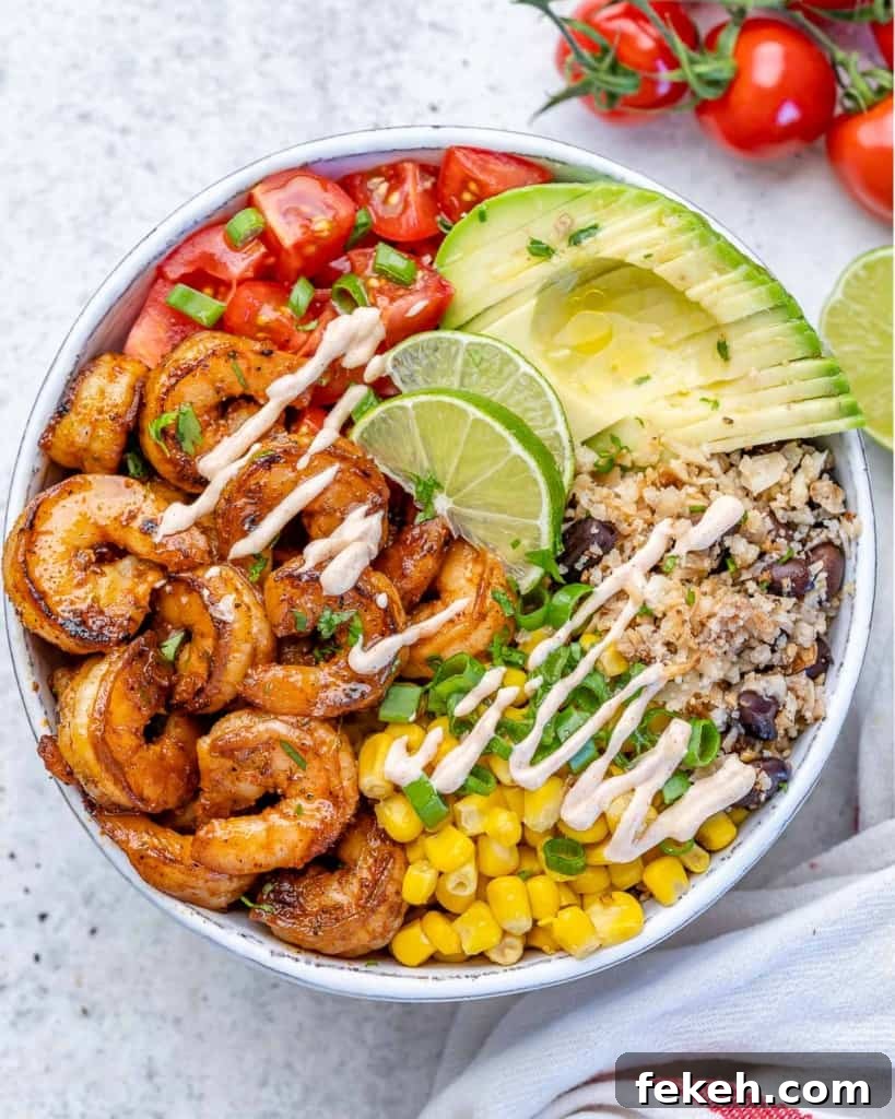 Spicy Lime Shrimp Burrito Bowl with Cilantro Rice 2 top view shrimp burrito with avocado, cauliflower rice, tomatoes, and corn