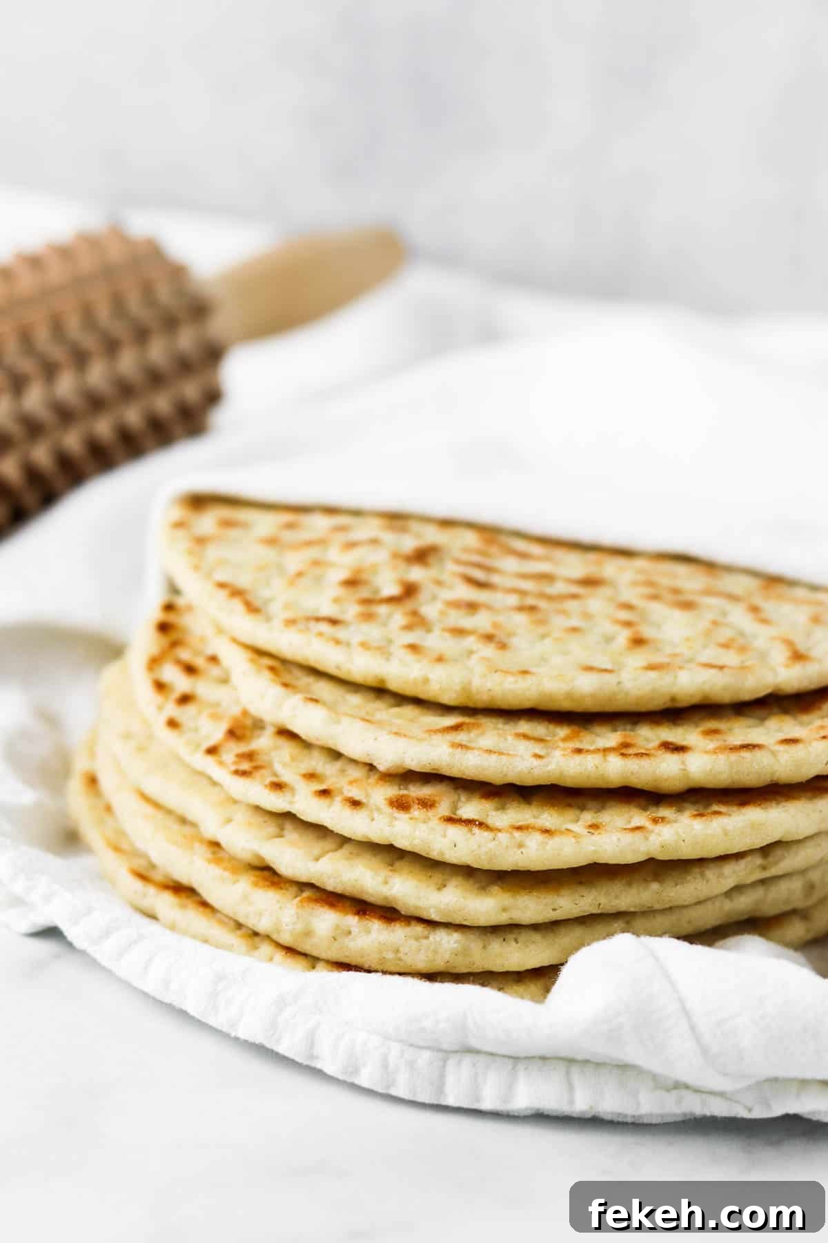 Soft Swedish Tunnbröd: Authentic Homemade Flatbread Recipe 5 Stack of flatbreads on a towel.