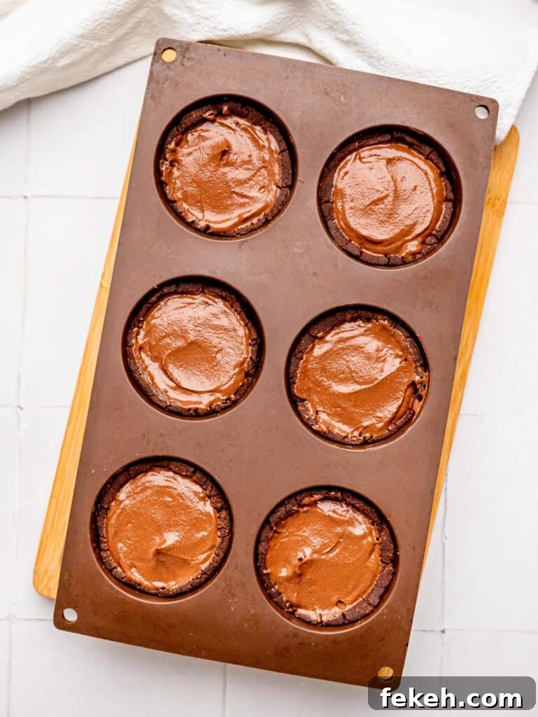 No-Bake Mini Triple Chocolate Cheesecakes Recipe 15 Mini Chocolate Cheesecake crusts filled with chocolate cheesecake filling.