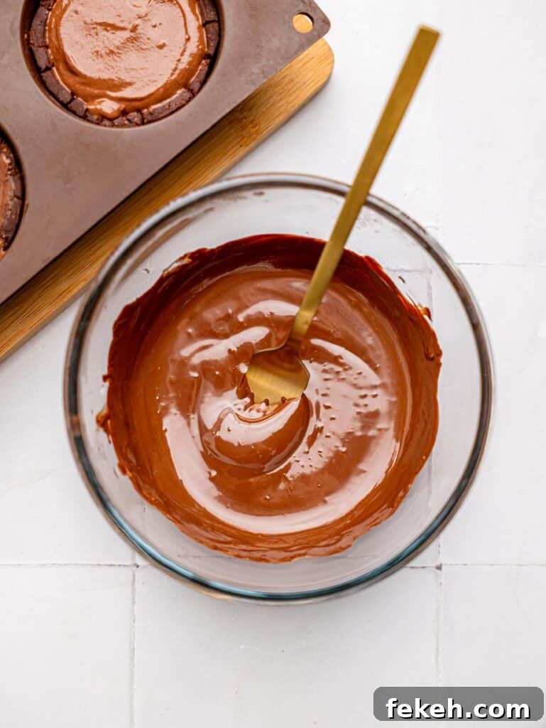 No-Bake Mini Triple Chocolate Cheesecakes Recipe 16 Melted Dark Chocolate in a bowl.