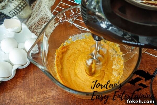 Jack-o'-Lantern Pumpkin Pie Pops Recipe for Halloween Treats 5 a pumpkin pie filling being made with a hand mixer