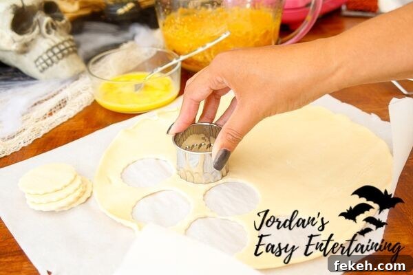 Jack-o'-Lantern Pumpkin Pie Pops Recipe for Halloween Treats 6 cutting out pie dough to make pumpkin pie pops as a Halloween sweet treat
