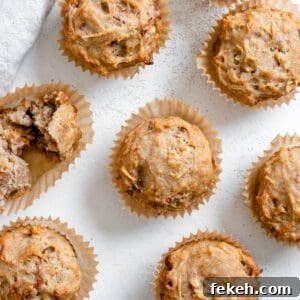 several completed Vegan Apple Muffins spread out on a white surface