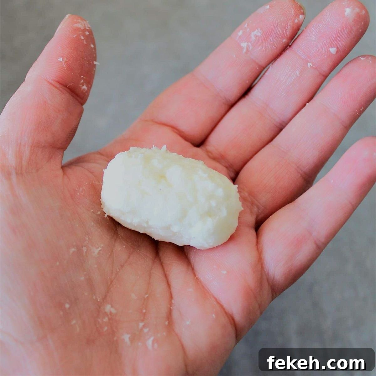 dough in small potato shape in hand.
