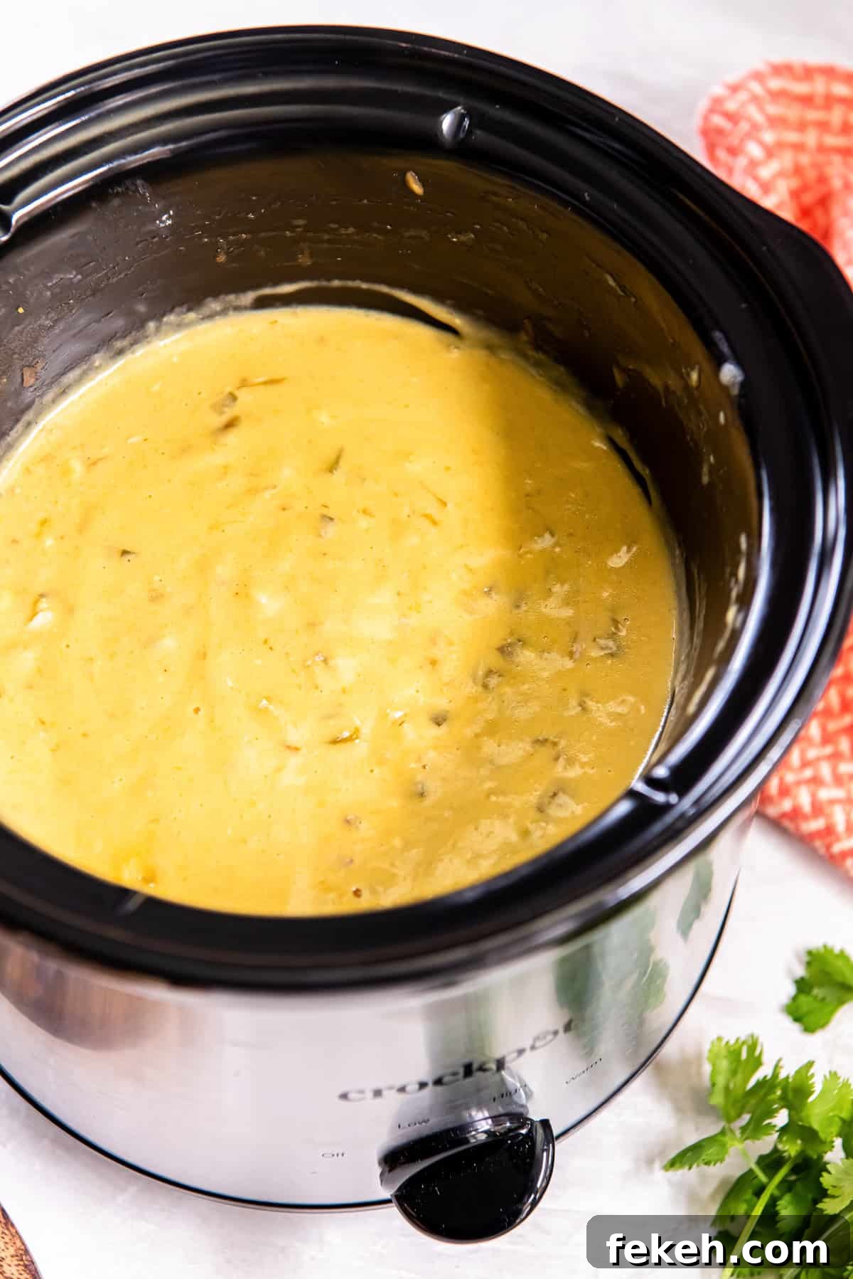 Slow Cooker Chicken Queso Dip Recipe for Game Day Snacks 6 Slow cooker chicken queso in a Crock-Pot.